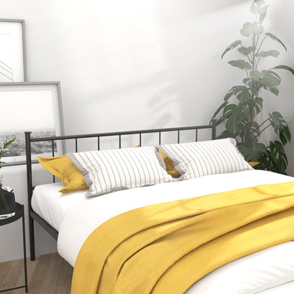 Queen size black metal bed frame; headboard and footboard, yellow bedding, framed pictures leaning on Tampa Home & Garden Store