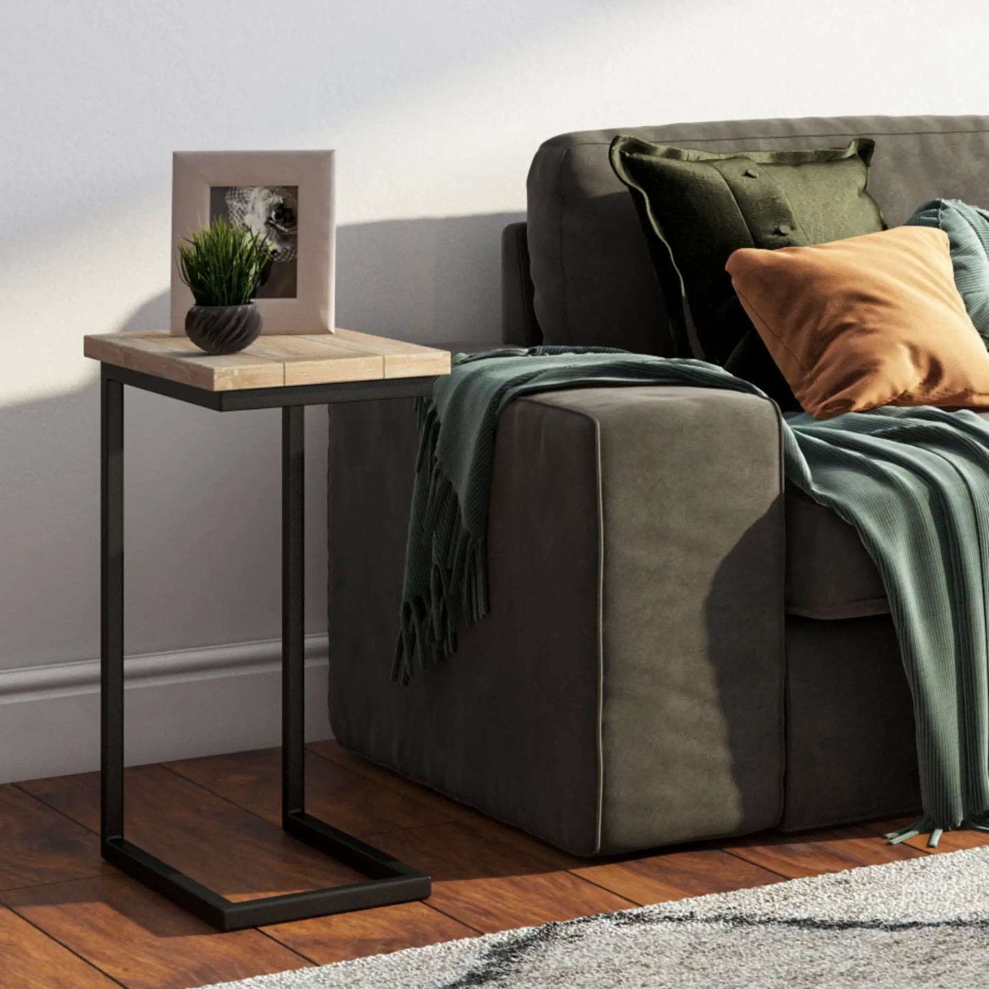 Skyler C Side Handcrafted Table with light wood top and black metal base beside gray sofa on Tampa Home & Garden Store