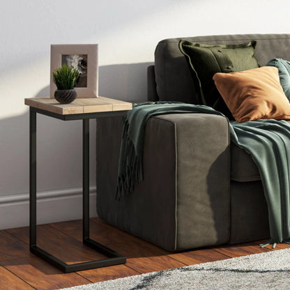 Skyler C Side Handcrafted Table with light wood top and black metal base beside gray sofa on Tampa Home & Garden Store