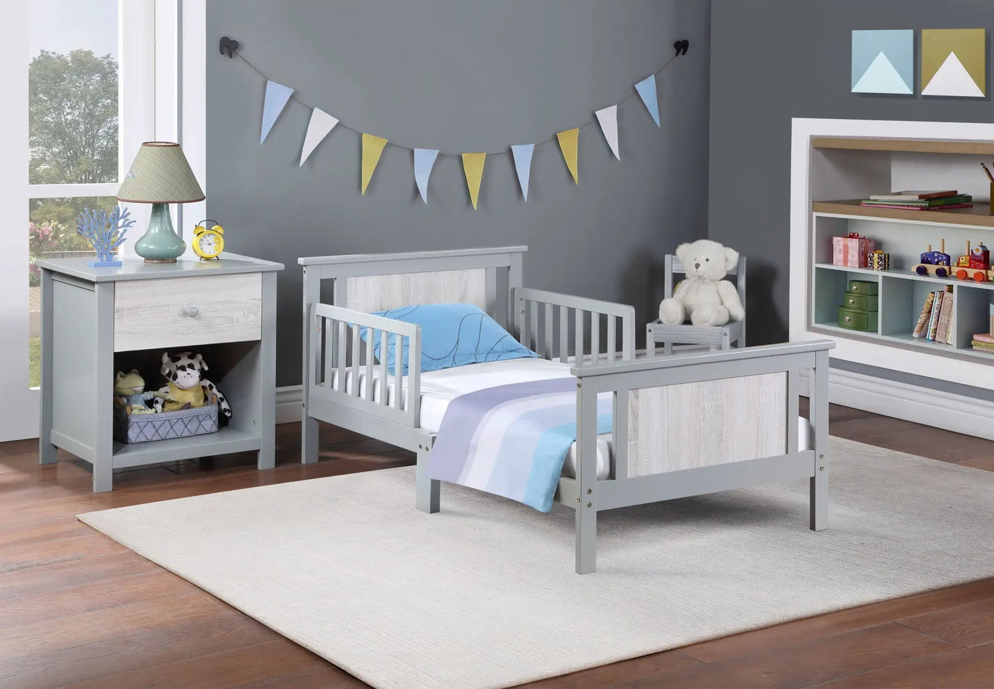 Connelly Reversible Panel Toddler Bed pair gray finish with light wood panels and blue bedding on Tampa Home & Garden Store