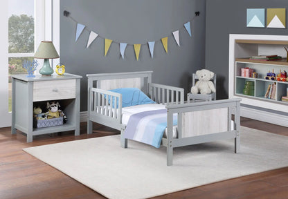 Connelly Reversible Panel Toddler Bed pair gray finish with light wood panels and blue bedding on Tampa Home & Garden Store