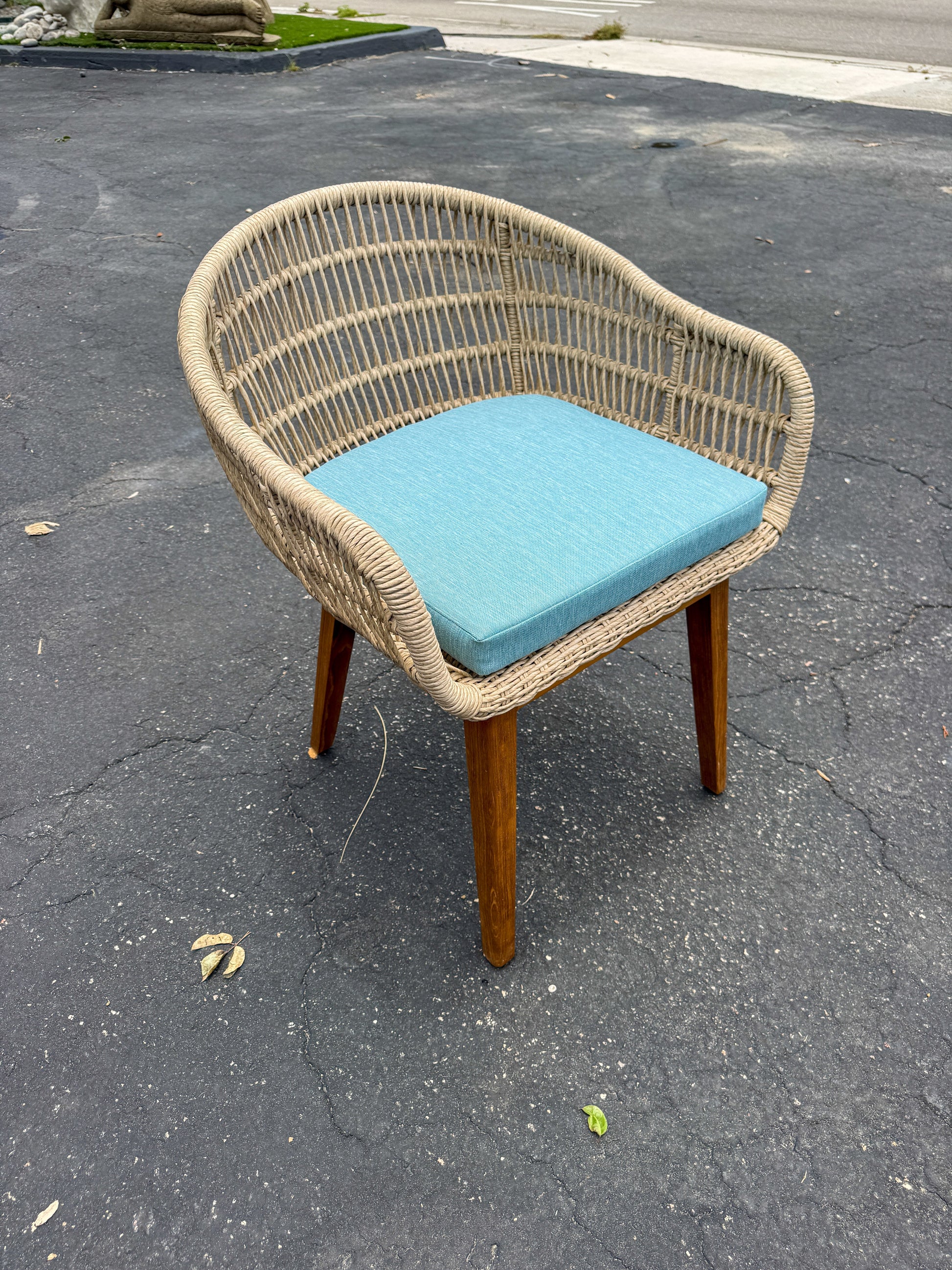 Synthetic rope and teak arm chair with blue cushion, outdoor wicker-style seat on teak legs on Tampa Home & Garden Store