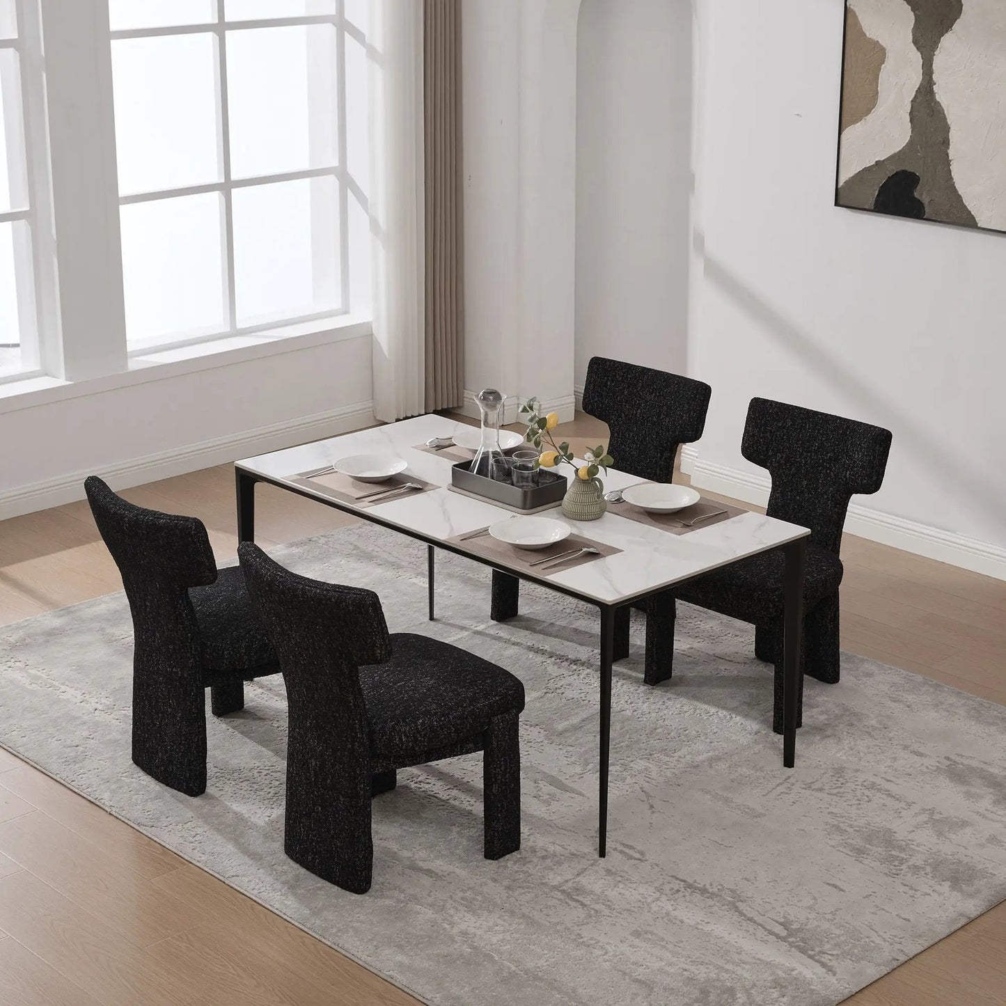Armless curved-back accent chairs in black textured fabric around a marble dining table on Tampa Home & Garden Store