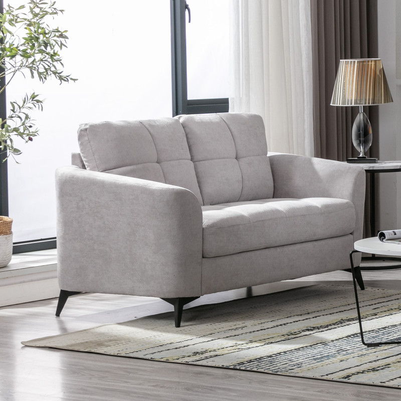 Woven fabric loveseat with tufted cushions and metal legs in gray in a bright living room on Tampa Home & Garden Store