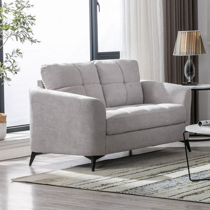 Woven fabric loveseat with tufted cushions and metal legs in gray in a bright living room on Tampa Home & Garden Store