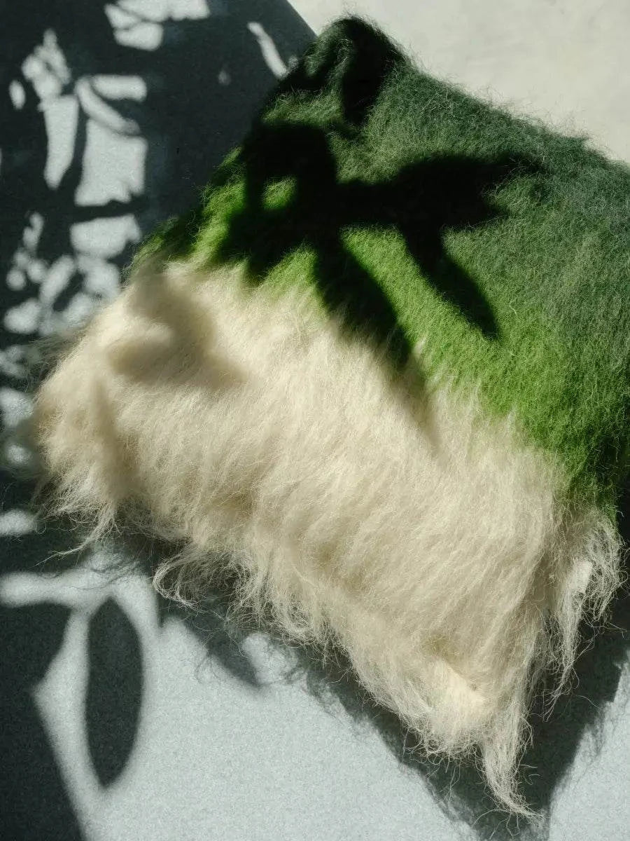 Handwoven wool throw pillow in emerald green and cream with brushed texture on Tampa Home & Garden Store