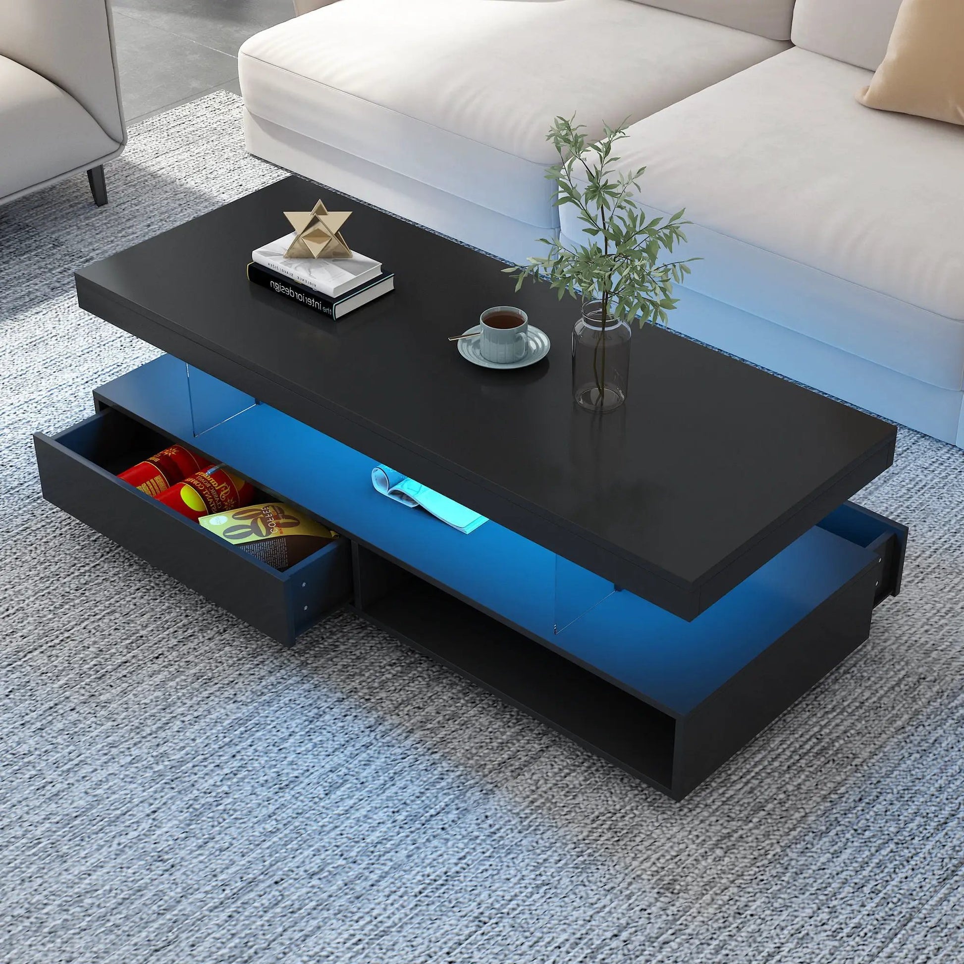 LED coffee table with 2 drawers; black exterior with blue interior, plant and books on top on Tampa Home & Garden Store