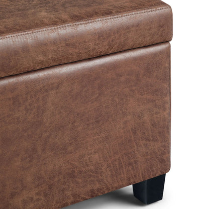 Avalon storage ottoman bench in brown distressed leather-look upholstery with black legs on Tampa Home & Garden Store