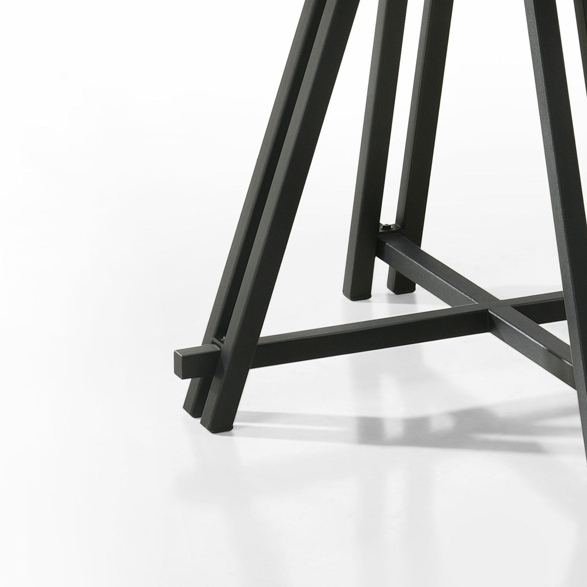 Tate round dining table with curved black metal base on Tampa Home & Garden Store