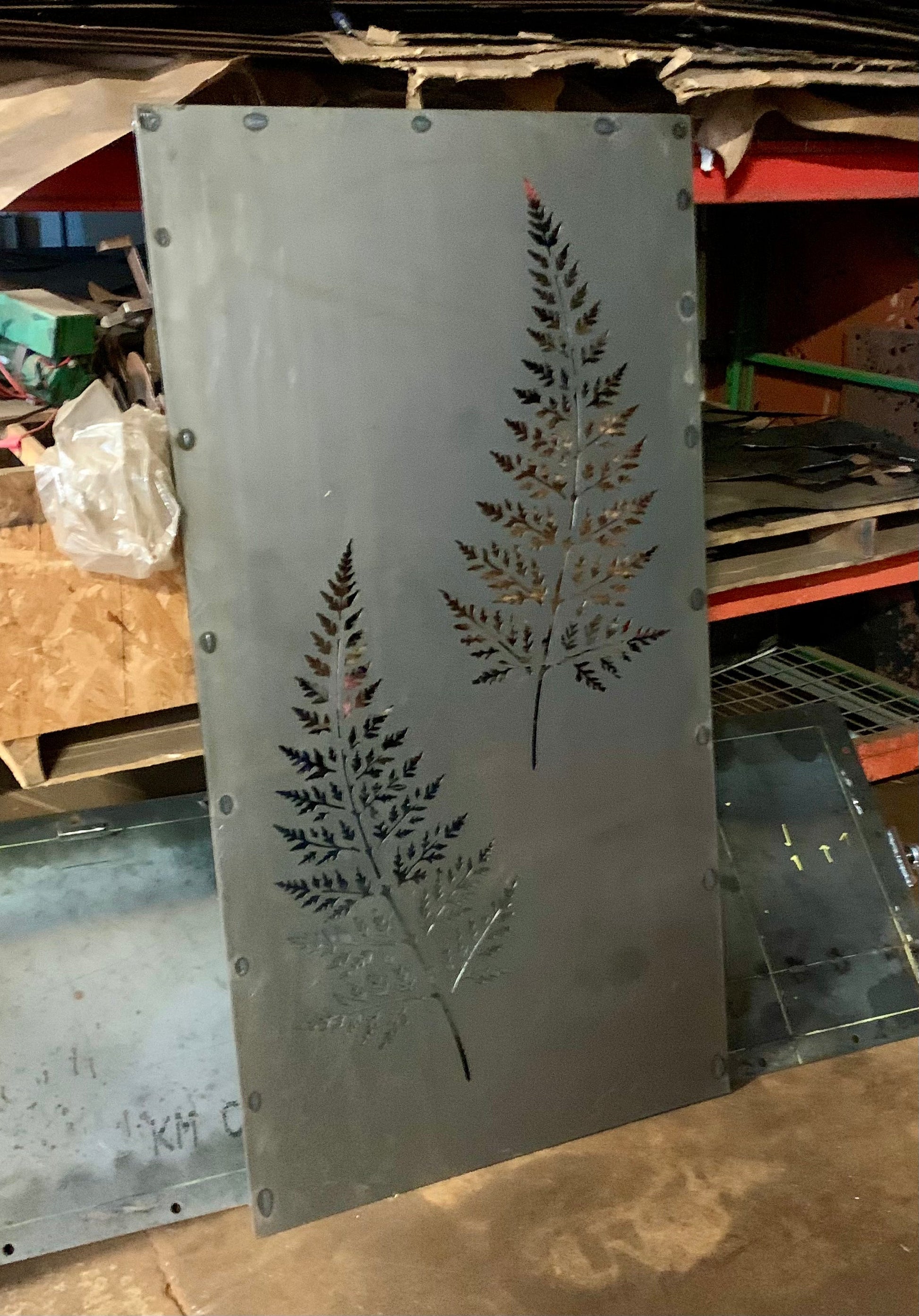 Outdoor metal privacy panel by Rustica Ornamentals in gray steel with fern leaf cutouts on Tampa Home & Garden Store