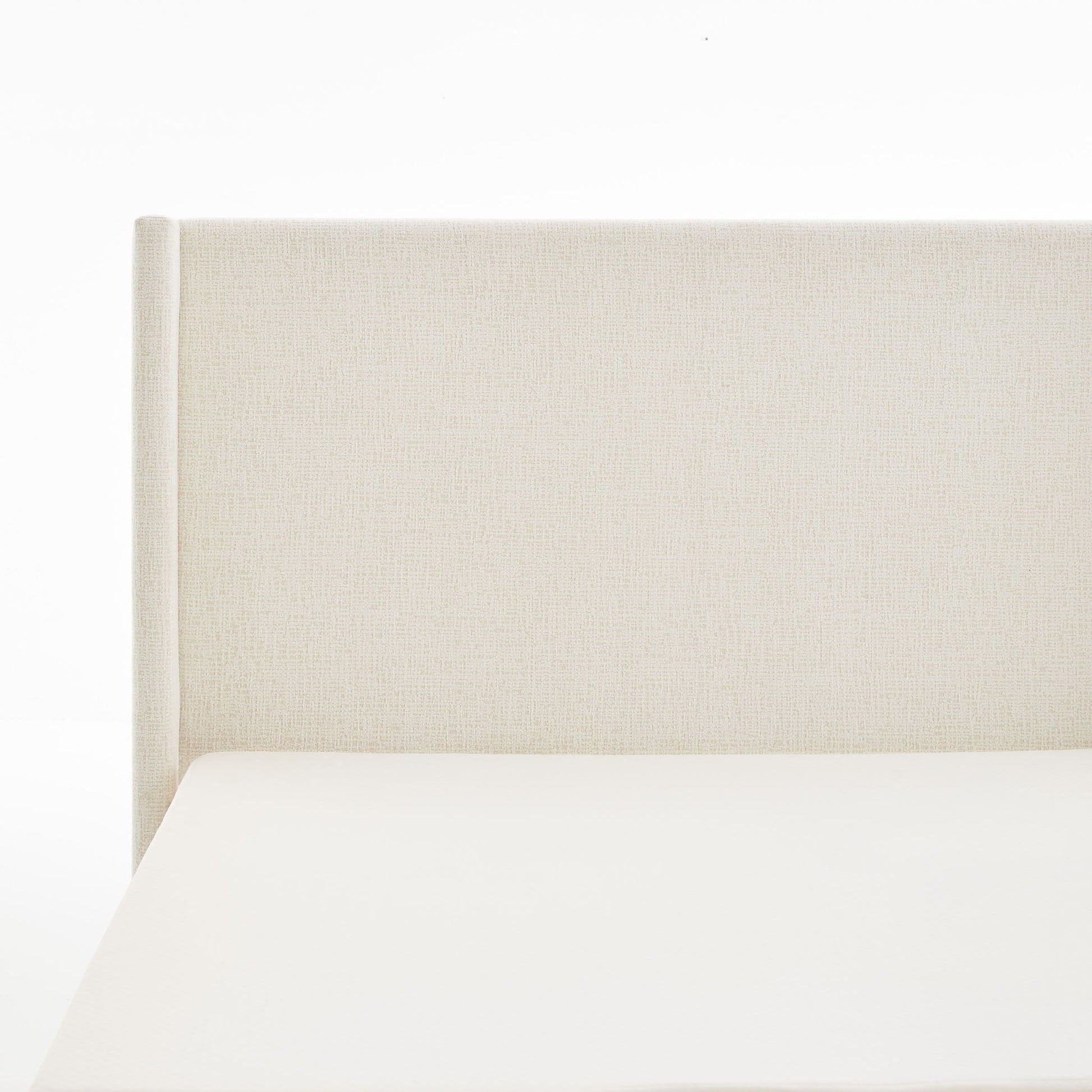 Hosford minimalist upholstered wingback bed with wood base platform in cream-beige fabric on Tampa Home & Garden Store