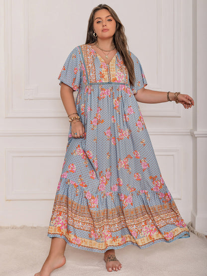 Stevvex plus-size flutter-sleeve maxi dress in blue with pink floral pattern, elegant flowy on Tampa Home & Garden Store