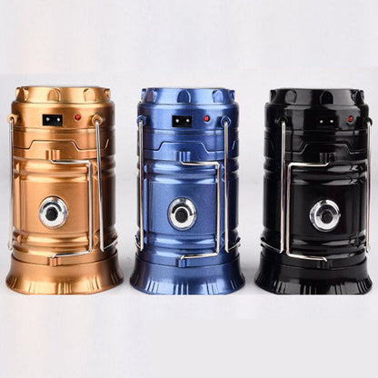 Solar charging camping lanterns in copper blue and black with metal handles and front lens on Tampa Home & Garden Store