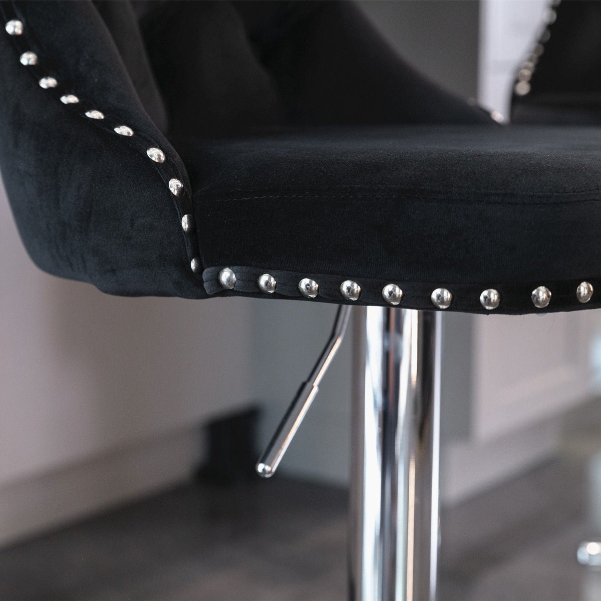 Set of 2 black swivel adjustable-height barstools with chrome legs and silver stud trim on Tampa Home & Garden Store
