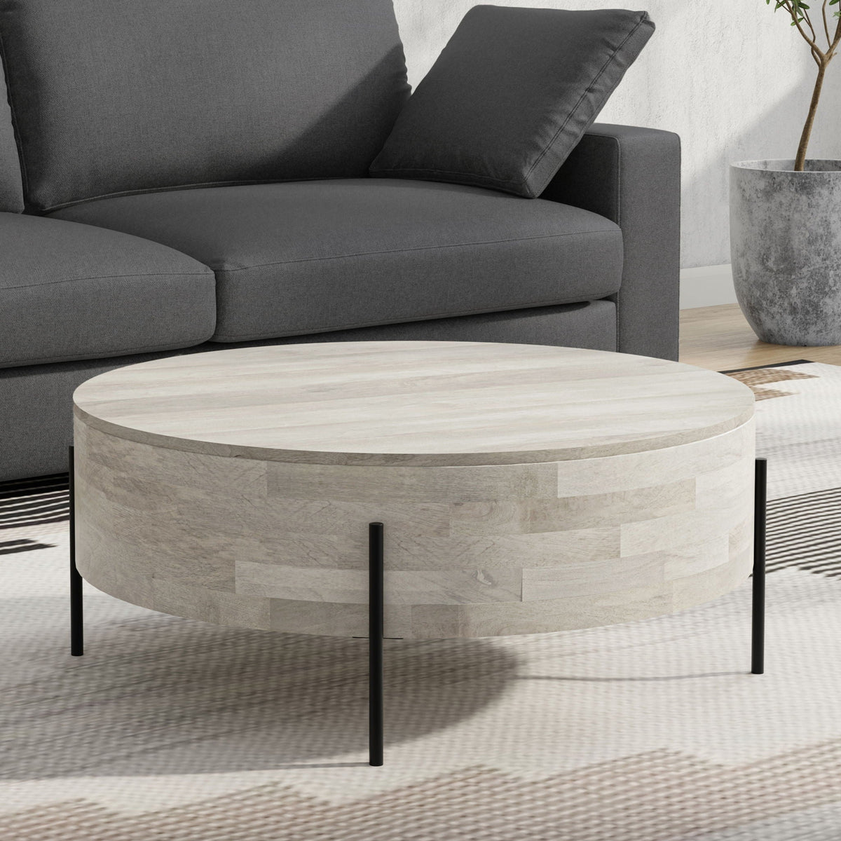 Round solid mango wood coffee table with black metal legs on Tampa Home & Garden Store