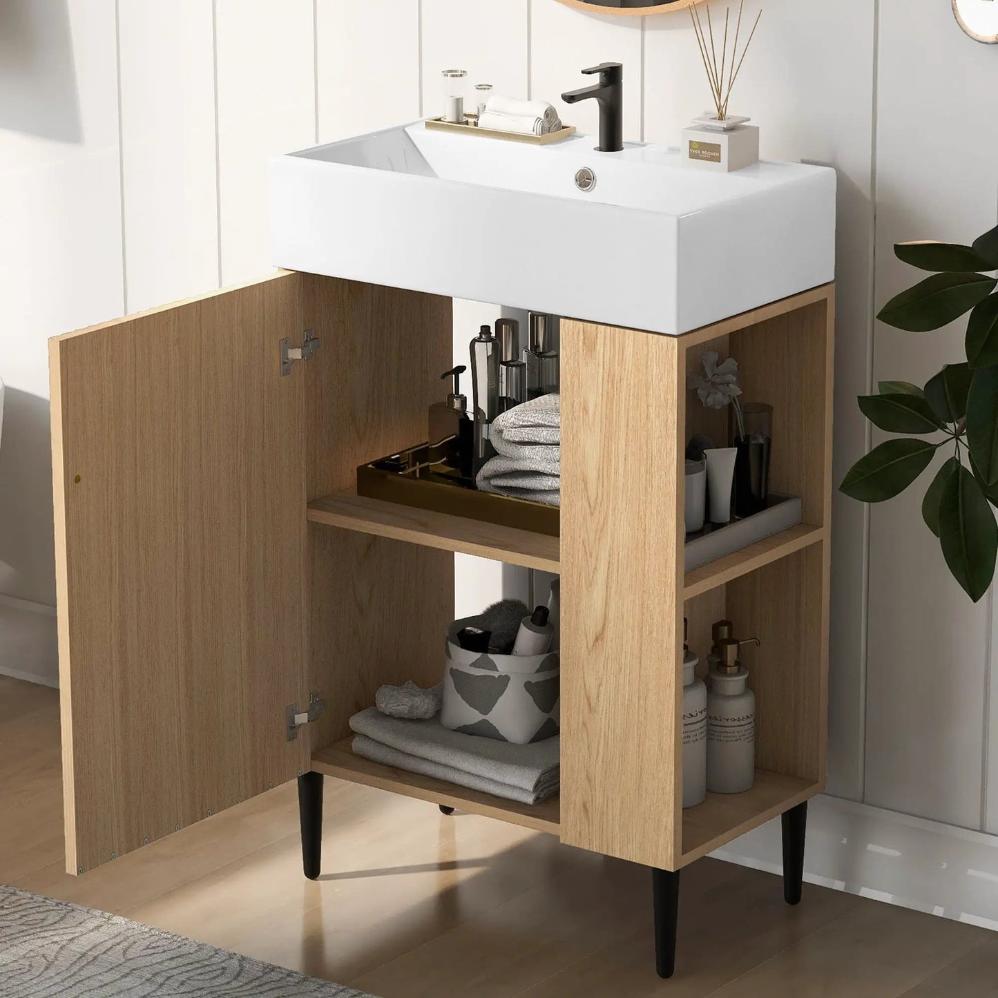 Bathroom vanity with white ceramic sink on light wood cabinet and black faucet on Tampa Home & Garden Store