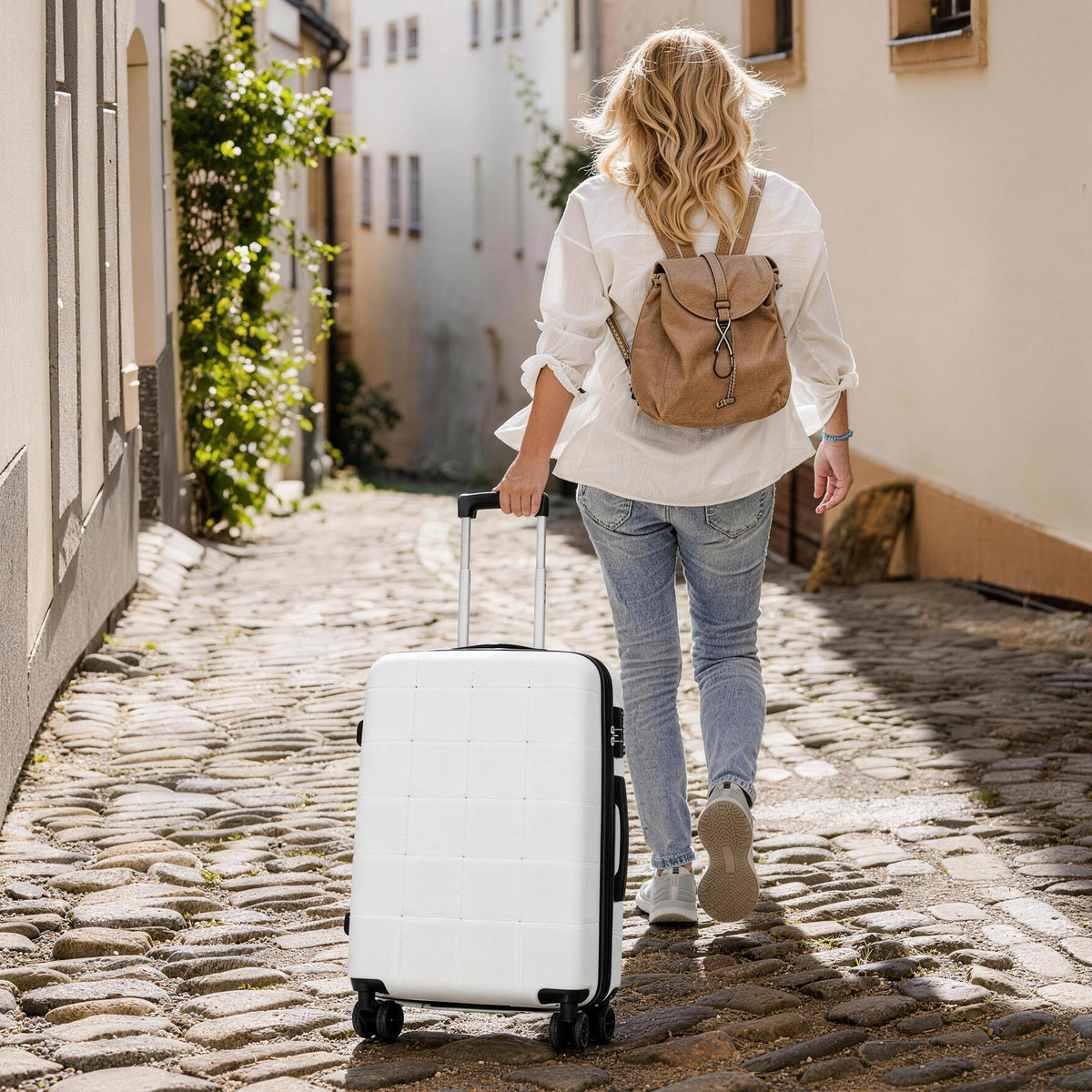 Hard-shell luggage with USB port, white 4-wheel spinner, traveler with backpack on Tampa Home & Garden Store