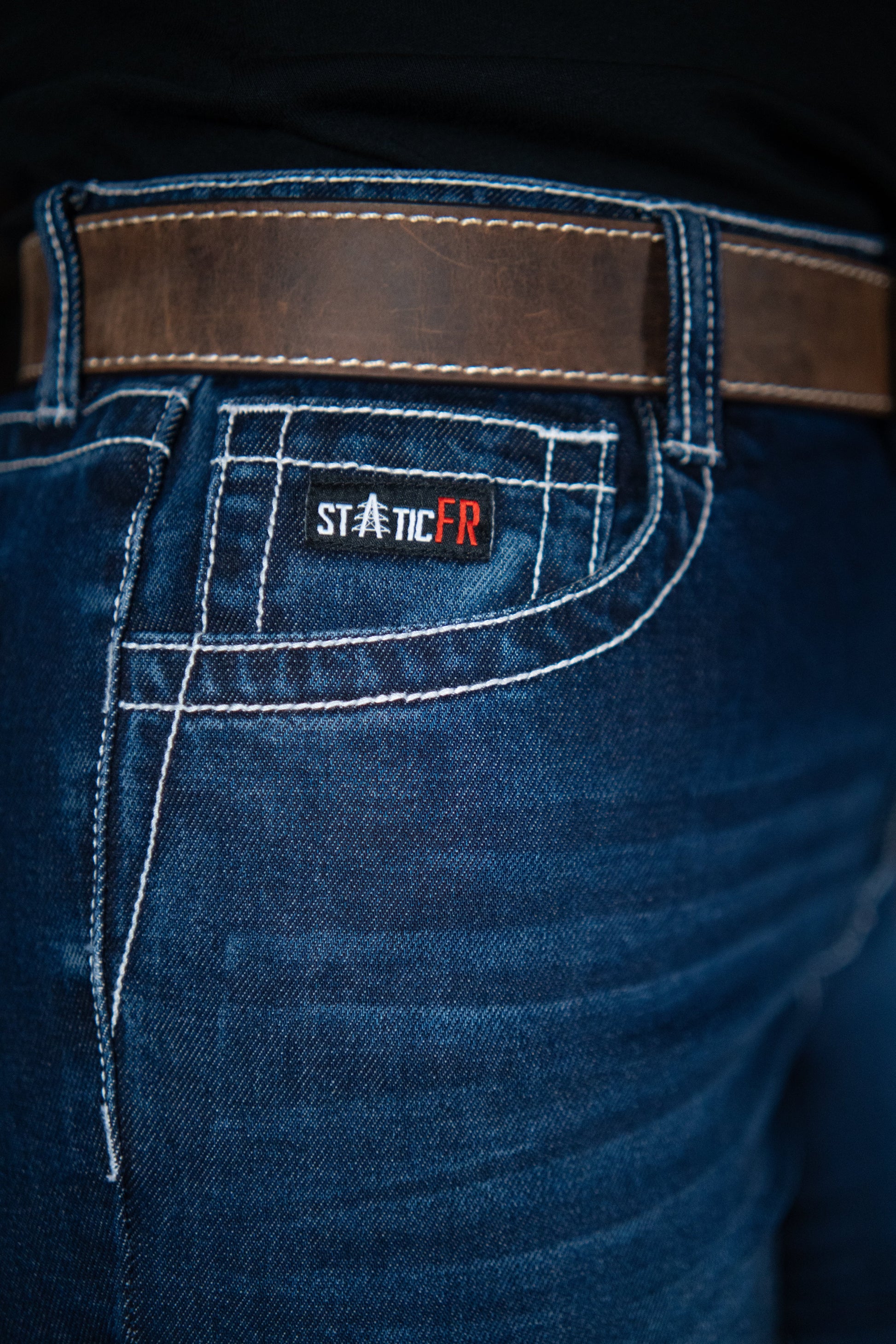 Women’s FR jeans denim with brown belt and Static FR patch on back pocket on Tampa Home & Garden Store
