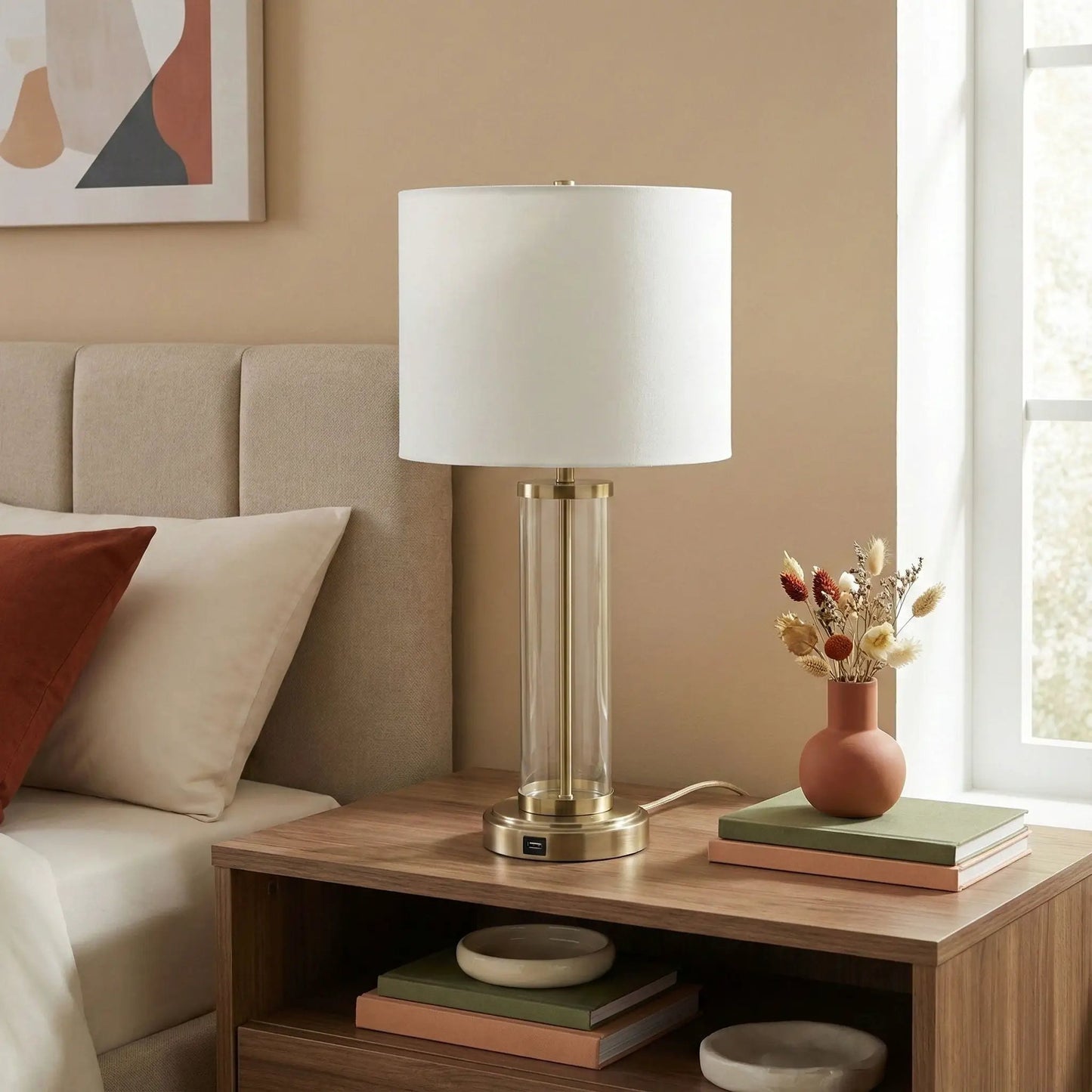 Luna table lamp with clear glass body, white shade and brass base on bedside table on Tampa Home & Garden Store