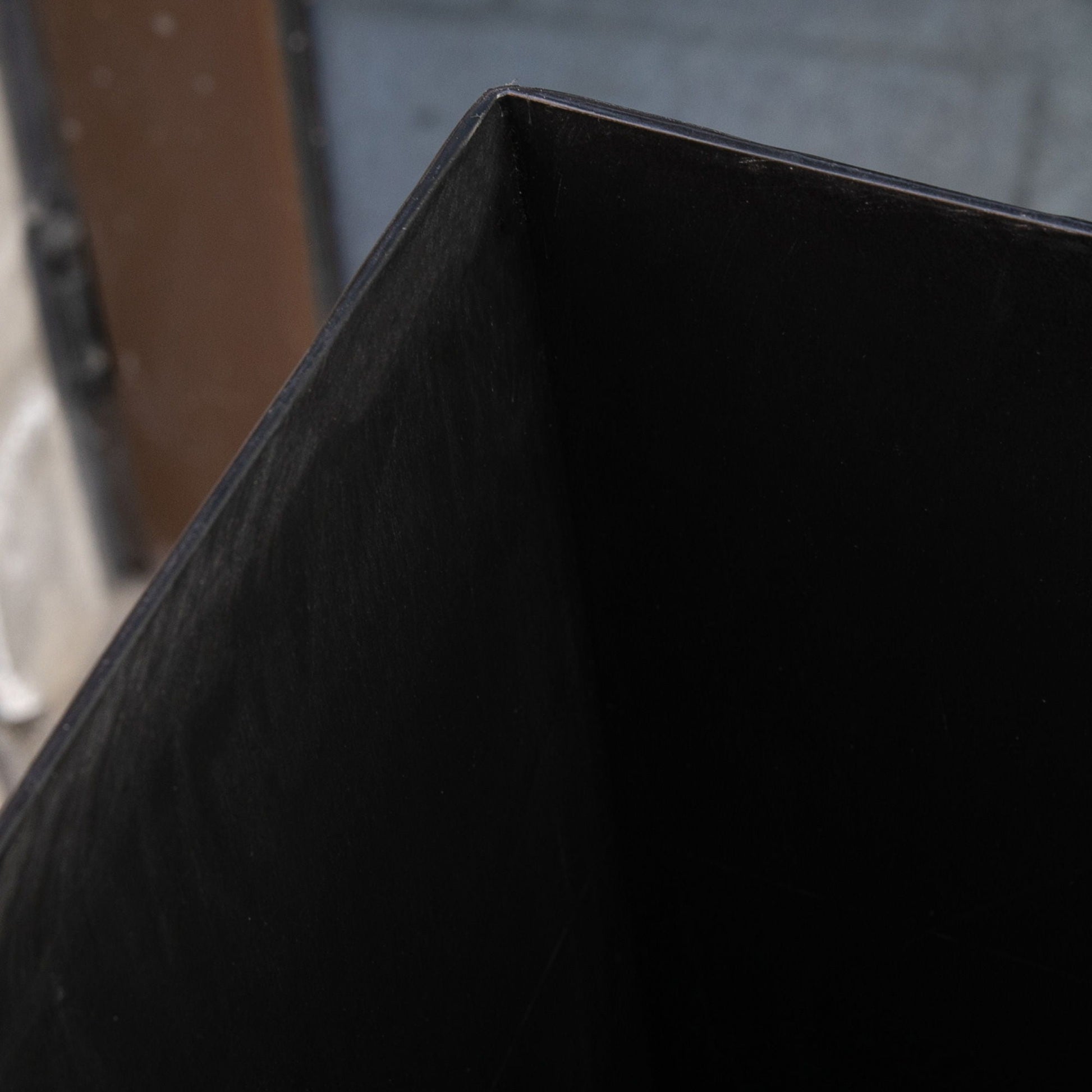 Outdoor tapered planter in faux wood plastic finish, black close-up on Tampa Home & Garden Store