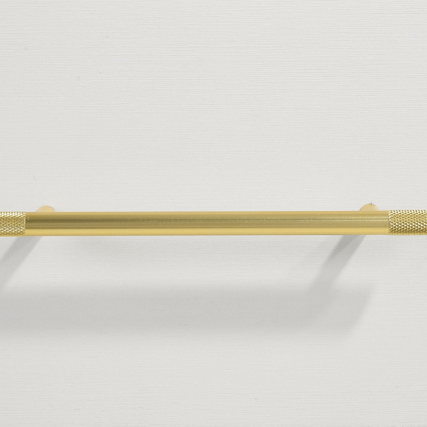 Gold towel bar with knurled ends mounted on white wall on Tampa Home & Garden Store