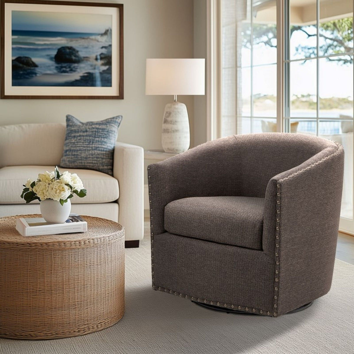 Luxurious pearl silver swivel chair with nailhead trim by HouseOfZazla in a living room on Tampa Home & Garden Store