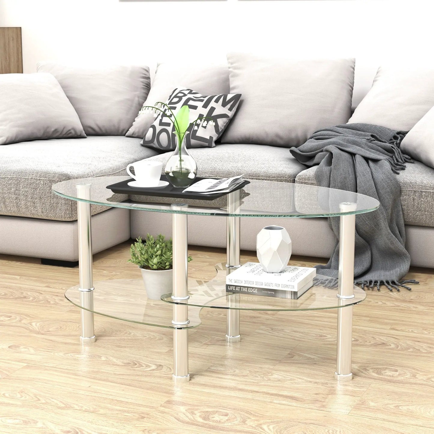 Transparent oval glass coffee table with oak wood legs and 3-tier glass shelves on Tampa Home & Garden Store