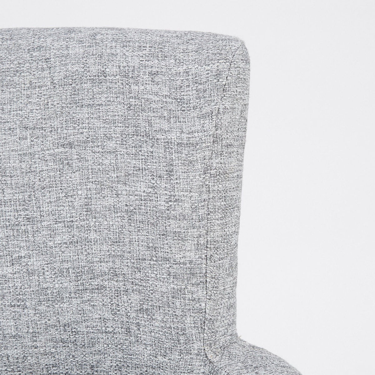 Elegant gray arm dining chair in textured upholstery, close-up of arm and corner on Tampa Home & Garden Store