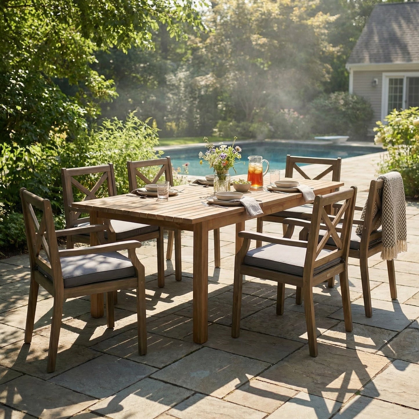 7-Piece Acacia Wood Outdoor Dining Set with slatted rectangular table and cross-back chairs with gray cushions on Tampa Home & Garden Store