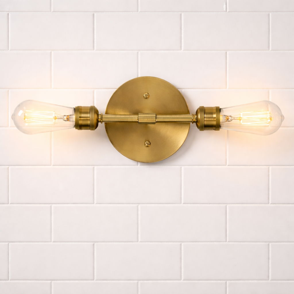 Reverie double lights bathroom wall sconce in brass with clear glass bulbs on backplate on Tampa Home & Garden Store