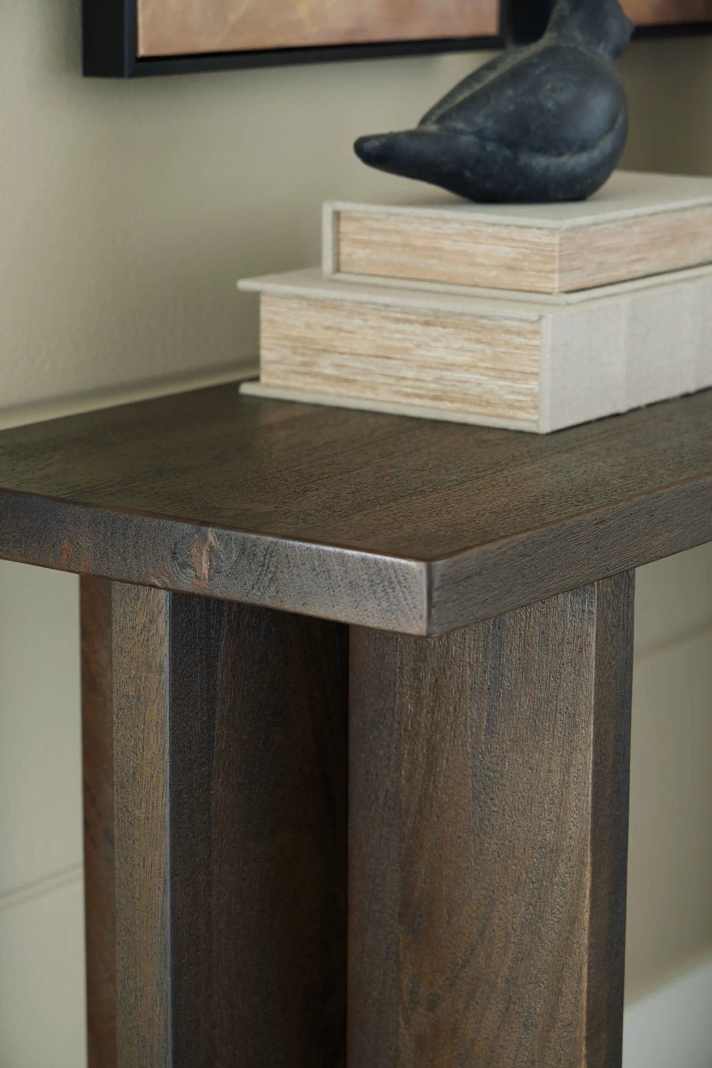 Jalenry console sofa table gray brown with wood legs two stacked books and black sculpture on Tampa Home & Garden Store