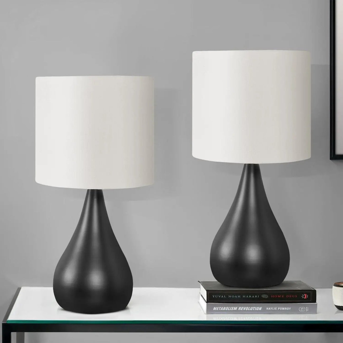 Table lamp set (2) in contemporary black with white drum shades and curved bases on a glass-top table by Unique Piece Furniture on Tampa Home & Garden Store