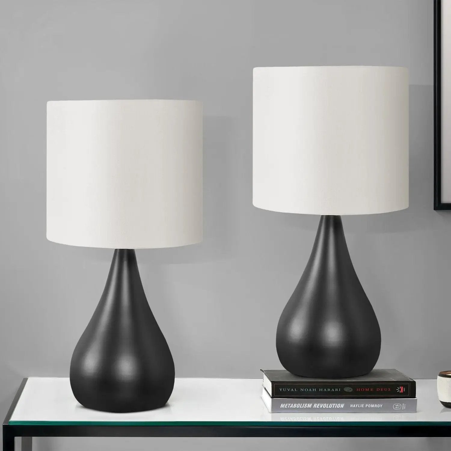 Table lamp set (2) in contemporary black with white drum shades and curved bases on a glass-top table by Unique Piece Furniture on Tampa Home & Garden Store