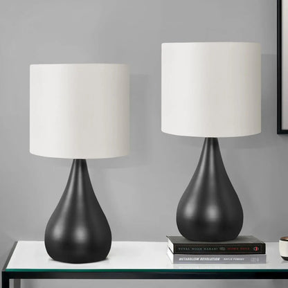 Table lamp set (2) in contemporary black with white drum shades and curved bases on a glass-top table by Unique Piece Furniture on Tampa Home & Garden Store