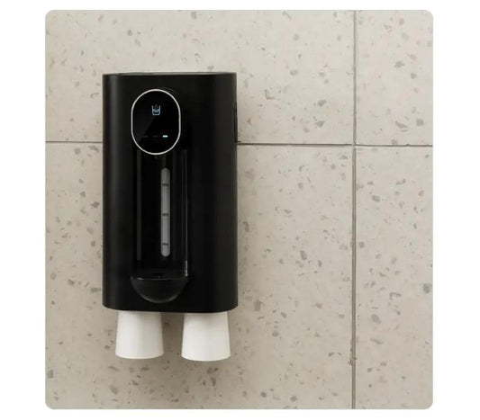 Black wall-mounted mouthwash dispenser with a visible level window and two white cups on Tampa Home & Garden Store