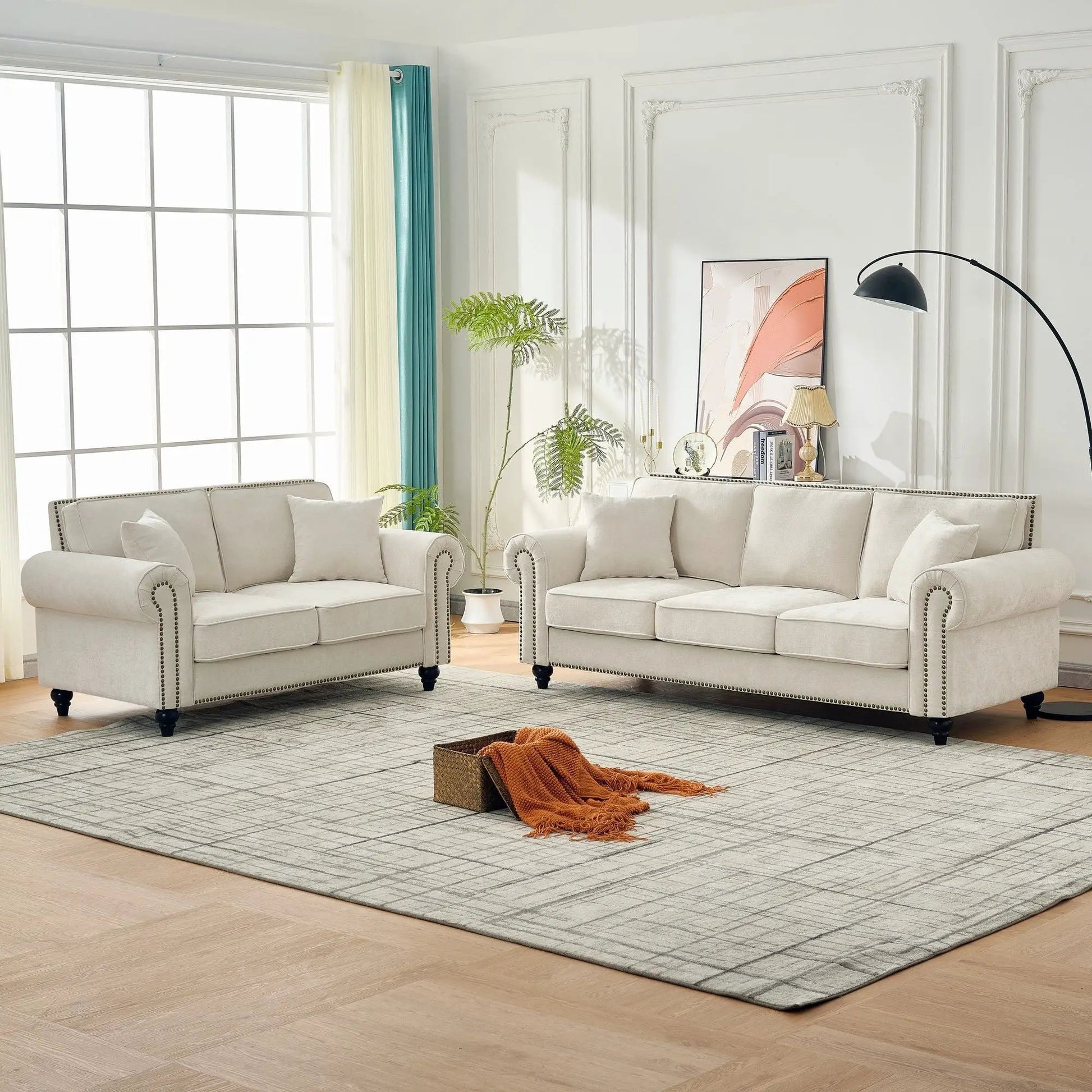 Two light gray 2-seat sofas with rolled arms and tufted upholstery by Unique Piece Furniture on Tampa Home & Garden Store