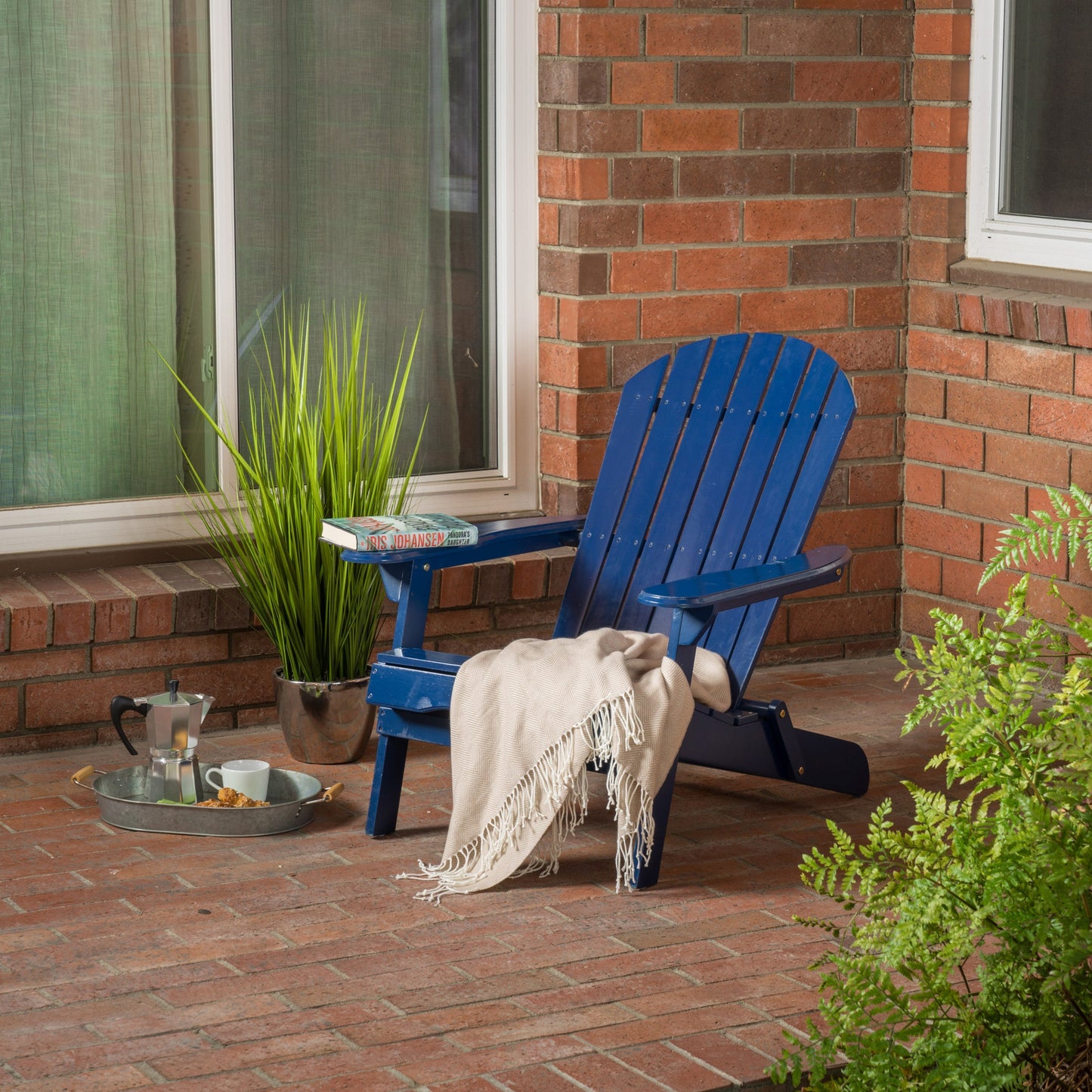 Malibu Adirondack Chair blue wooden outdoor seating on brick patio with blanket and plant on Tampa Home & Garden Store