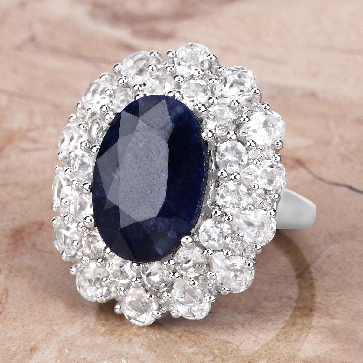 Ring with dyed sapphire center and halo of clear topaz in sterling silver on Tampa Home & Garden Store
