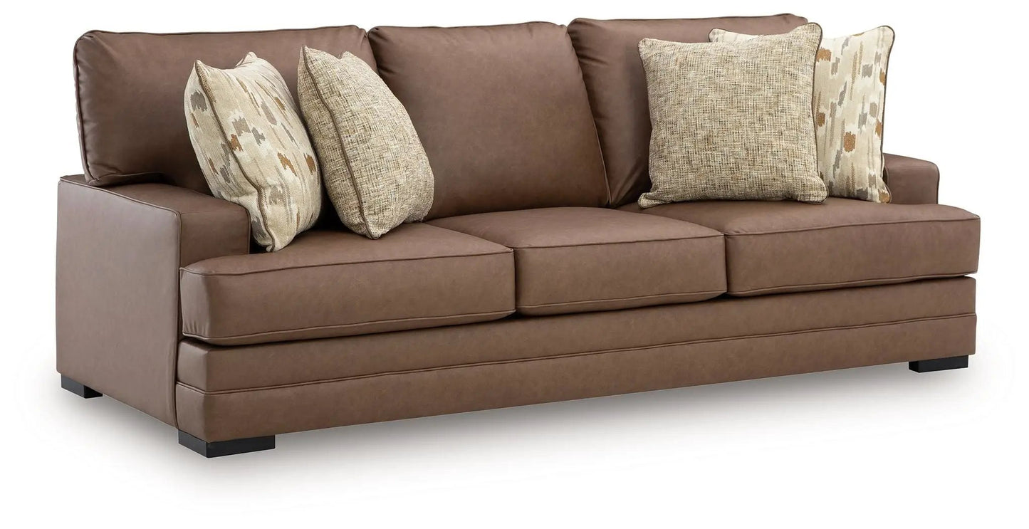 VillaCourt sofa caramel brown leather, stationary 3-seat with beige pillows on Tampa Home & Garden Store