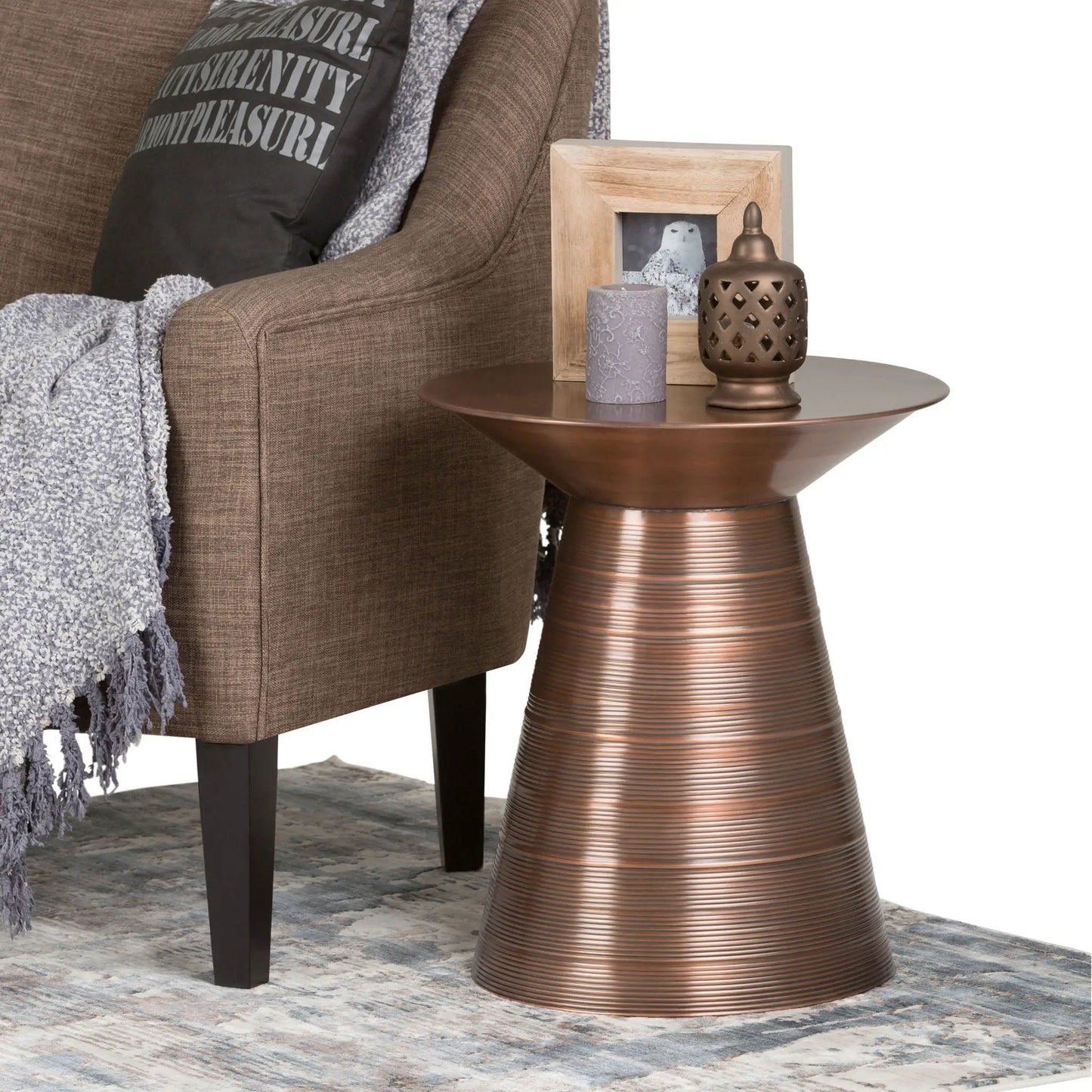 Sheridan handcrafted copper-toned metal accent table with ribbed pedestal beside sofa on Tampa Home & Garden Store