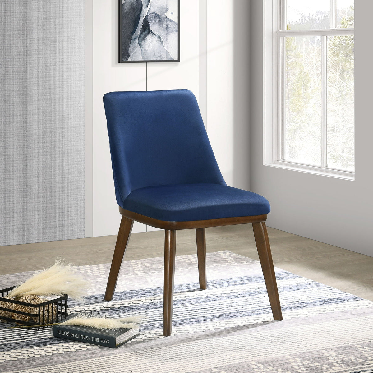 Blue upholstered mid-century dining chair with solid wood frame in a bright room on Tampa Home & Garden Store