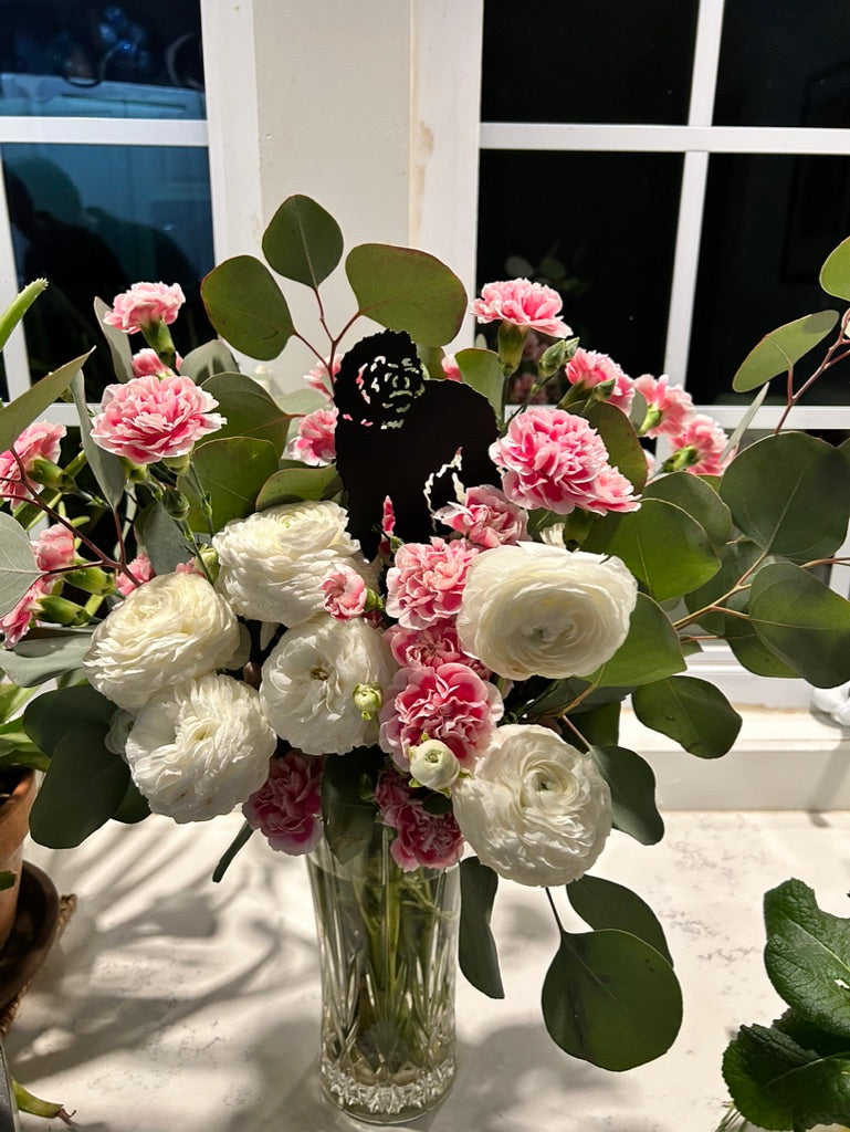Labradoodle Plant Stake by Rustica Ornamentals marker amid white ranunculus and pink blooms on Tampa Home & Garden Store