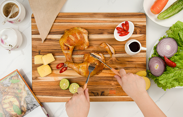 Teak cutting board natural solid wood 18-inch kitchen board with roasted chicken on counter on Tampa Home & Garden Store