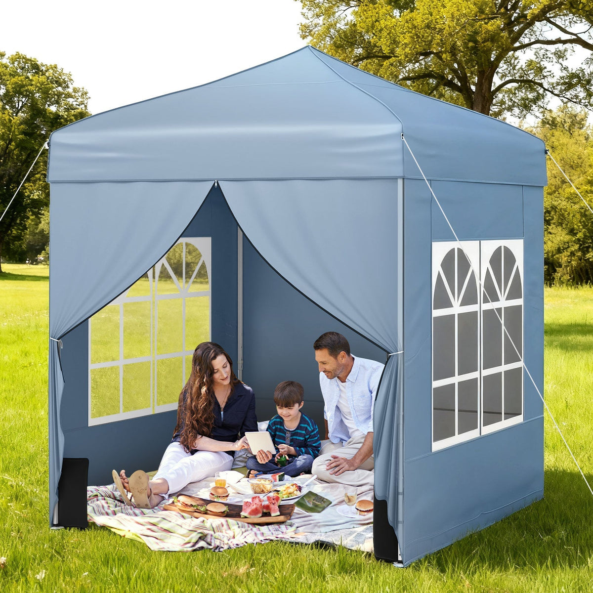 GemGear blue 6.5x6.5 ft popup canopy tent with 4 sidewalls and wheeled bag, family picnic on grass on Tampa Home & Garden Store