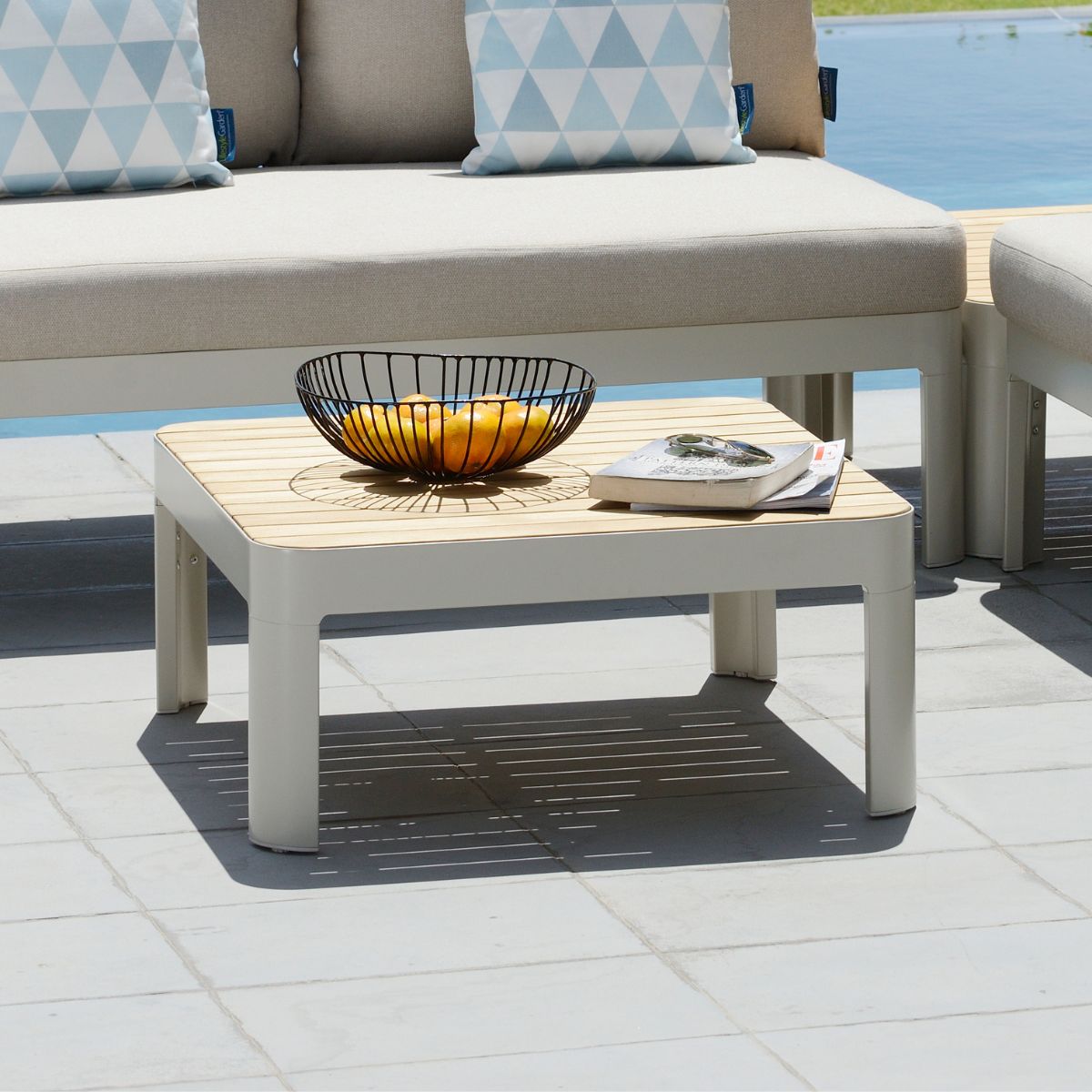 Portals Light Square Coffee Table with wood slat top and white frame outdoors on Tampa Home & Garden Store