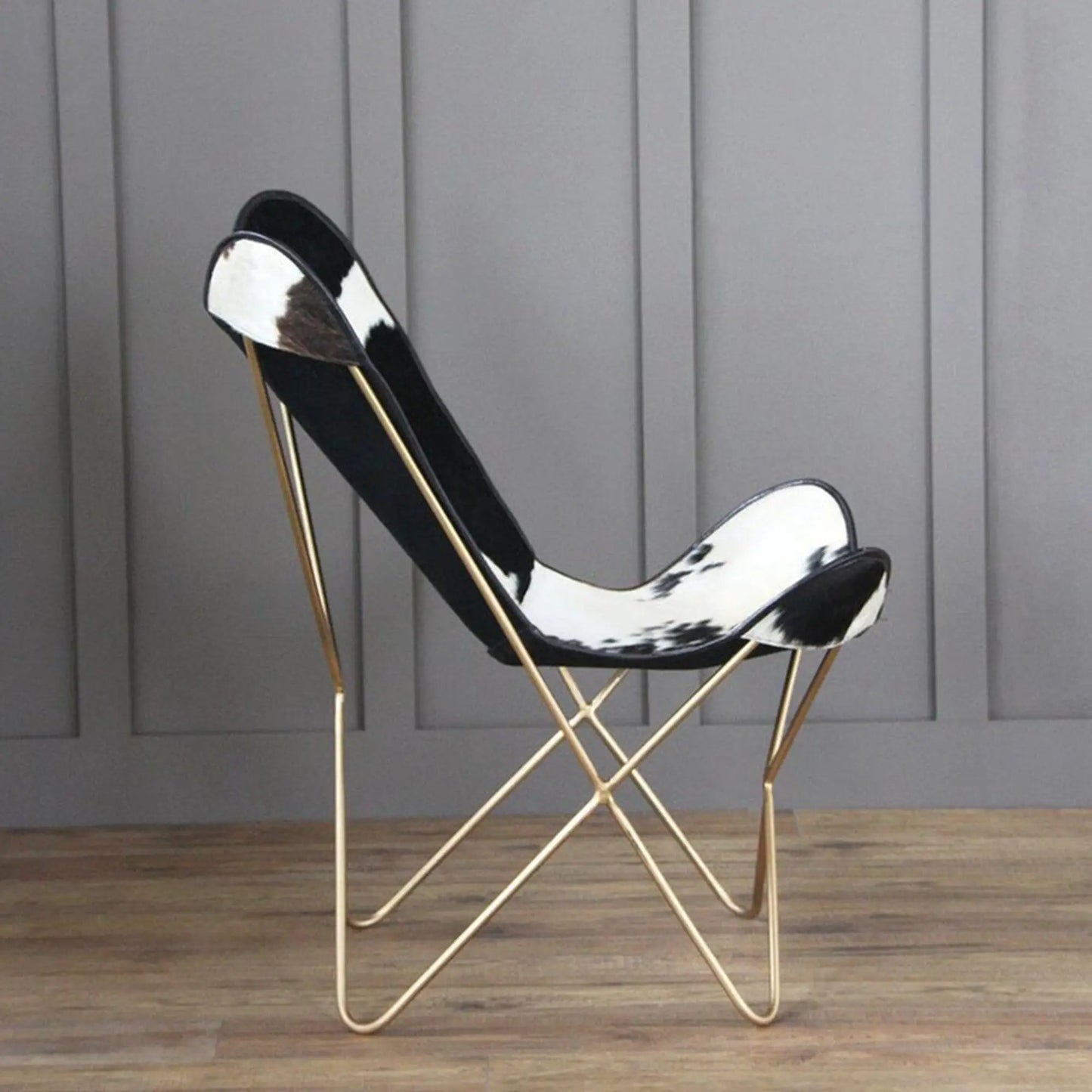 The Holsteins Butterfly Chair by Classy Leather Bags with black white cowhide seat gold frame on Tampa Home & Garden Store