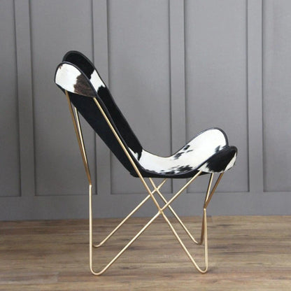 The Holsteins Butterfly Chair by Classy Leather Bags with black white cowhide seat gold frame on Tampa Home & Garden Store