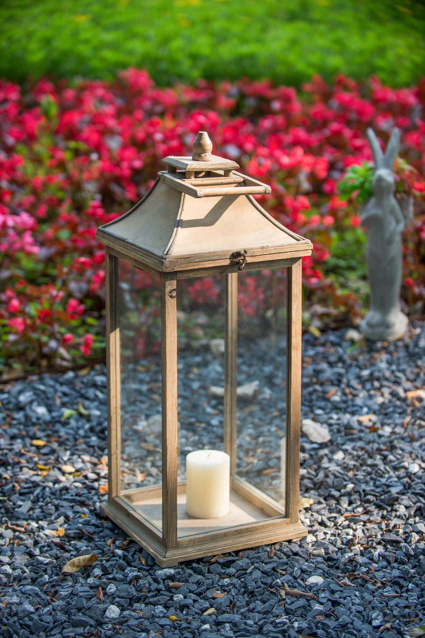 Ivory wooden lantern with glass panels and latch, candle inside, garden setting on Tampa Home & Garden Store