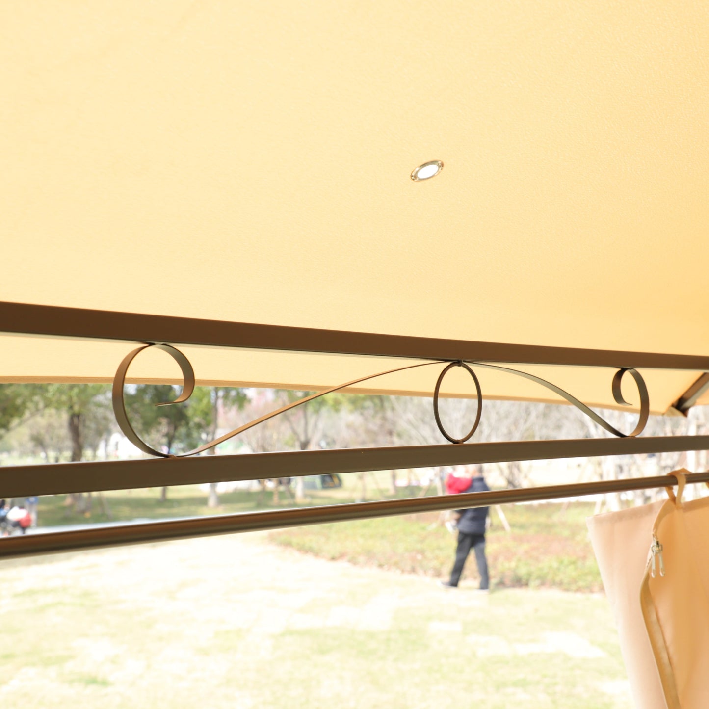 Khaki outdoor gazebo canopy interior with ceiling light and curved metal scrolls on window on Tampa Home & Garden Store