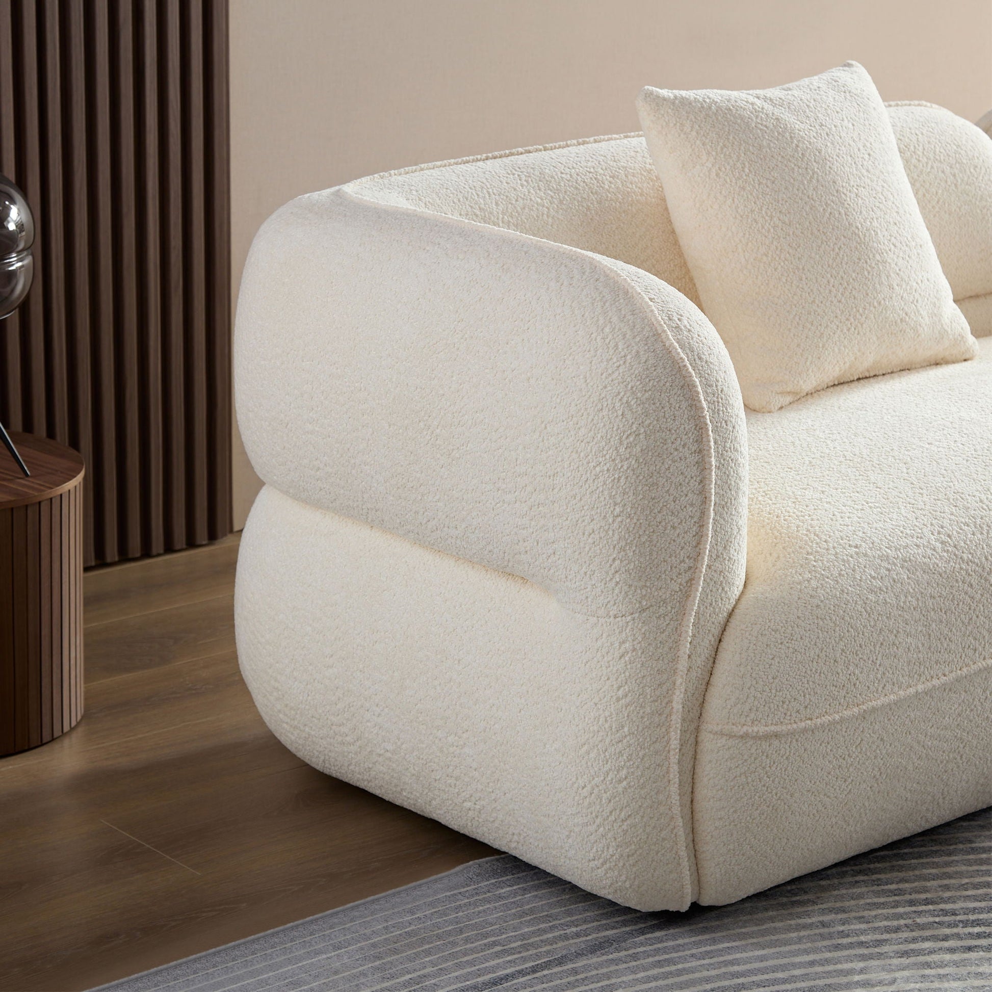 Sectional sofa in cream boucle fabric with rounded arms and plush cushions on Tampa Home & Garden Store